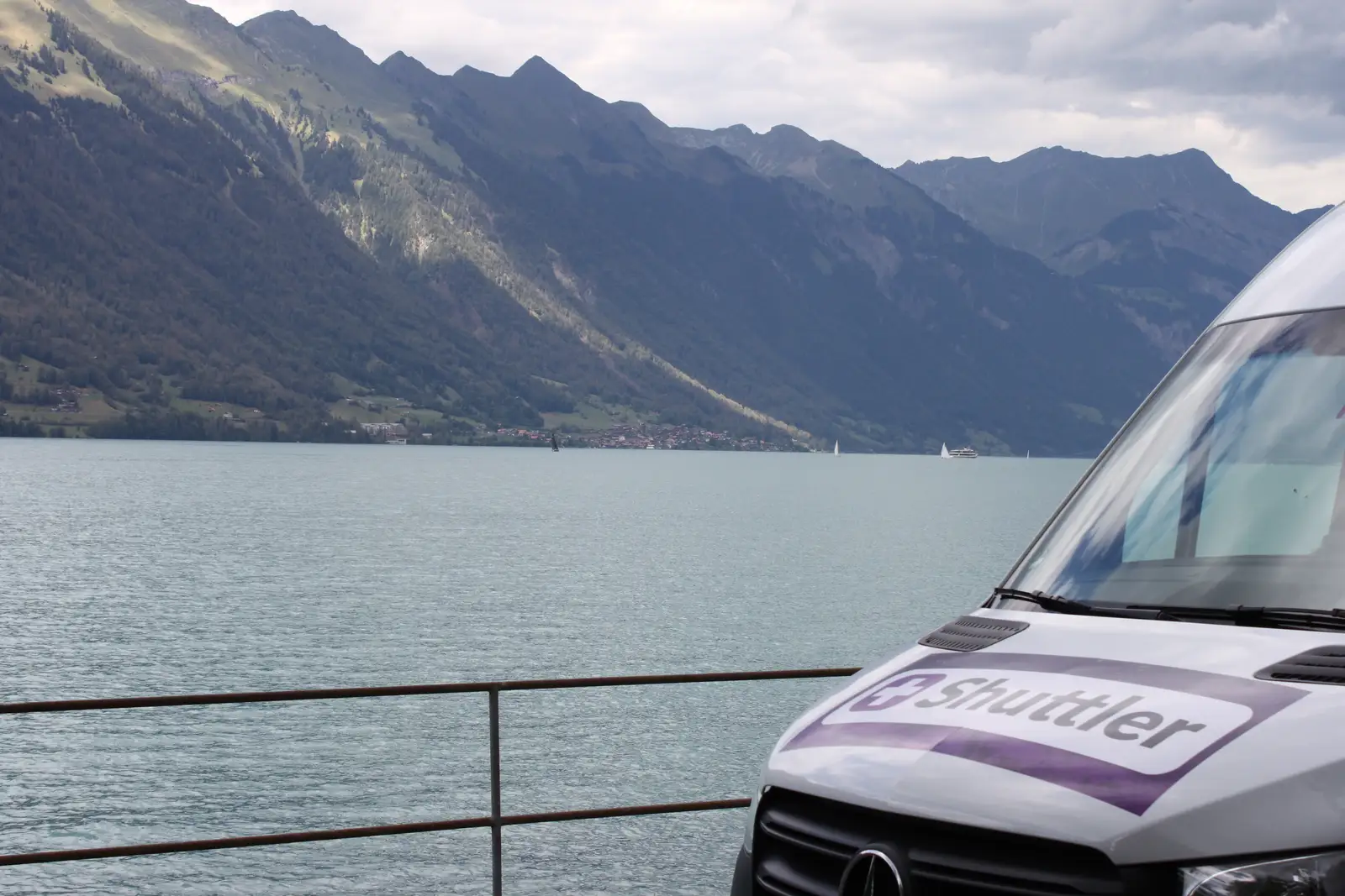 A Shuttler minibus by a Swiss lake